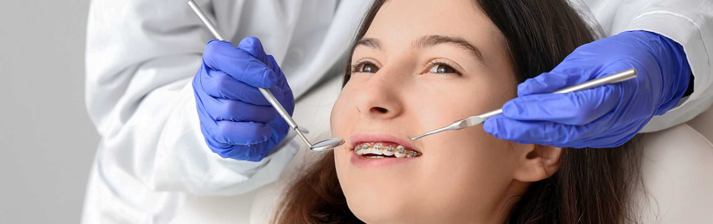 A orthodontist checking a patients mouth