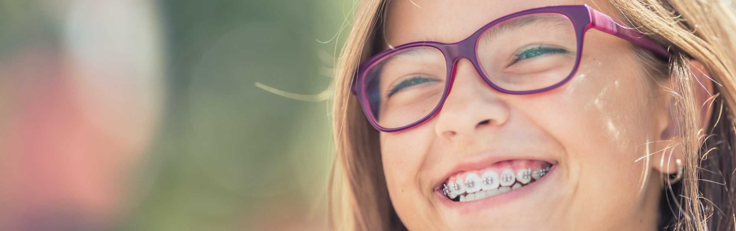 A girl with glasses smiling