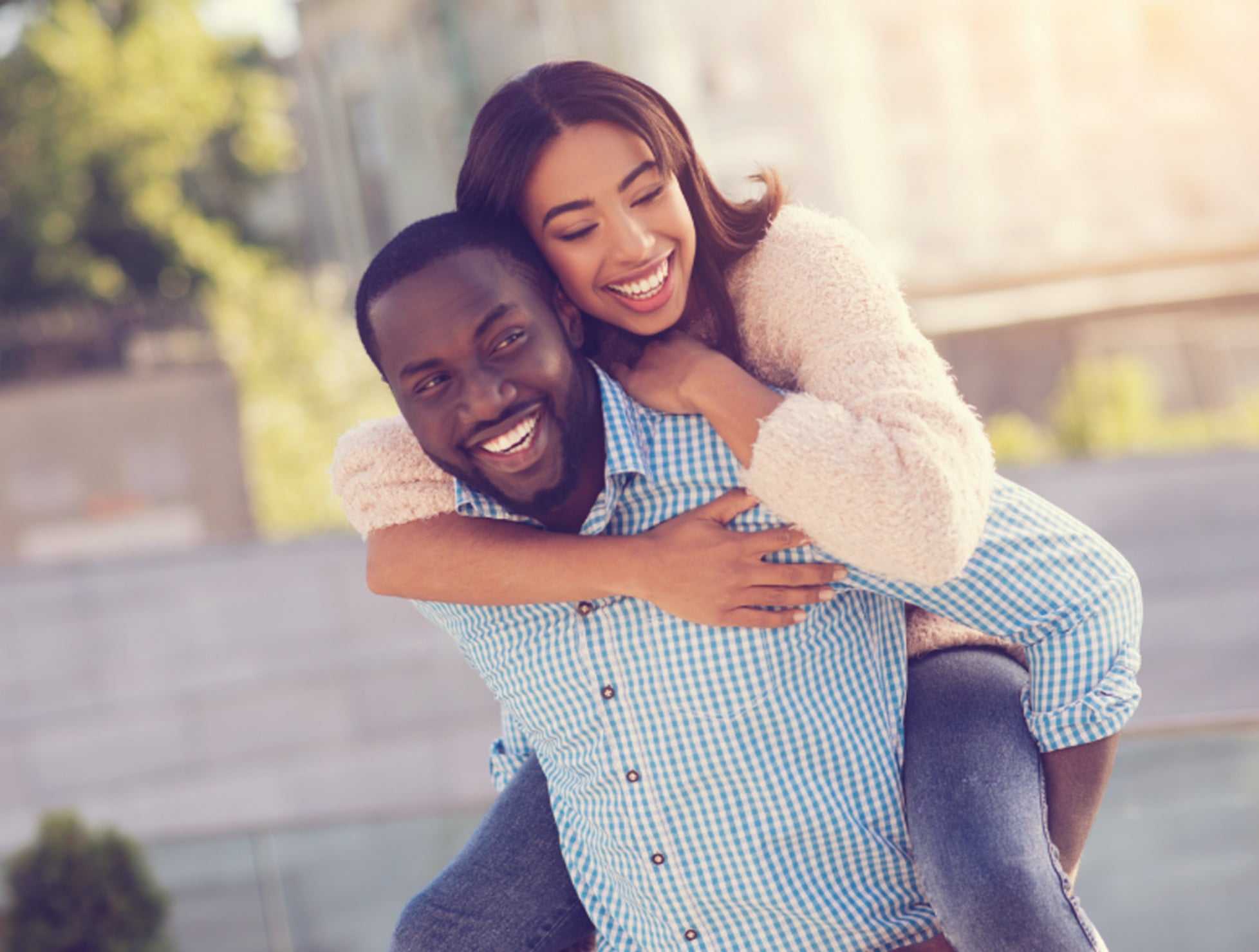 A man and a woman smiling while the man and having fun