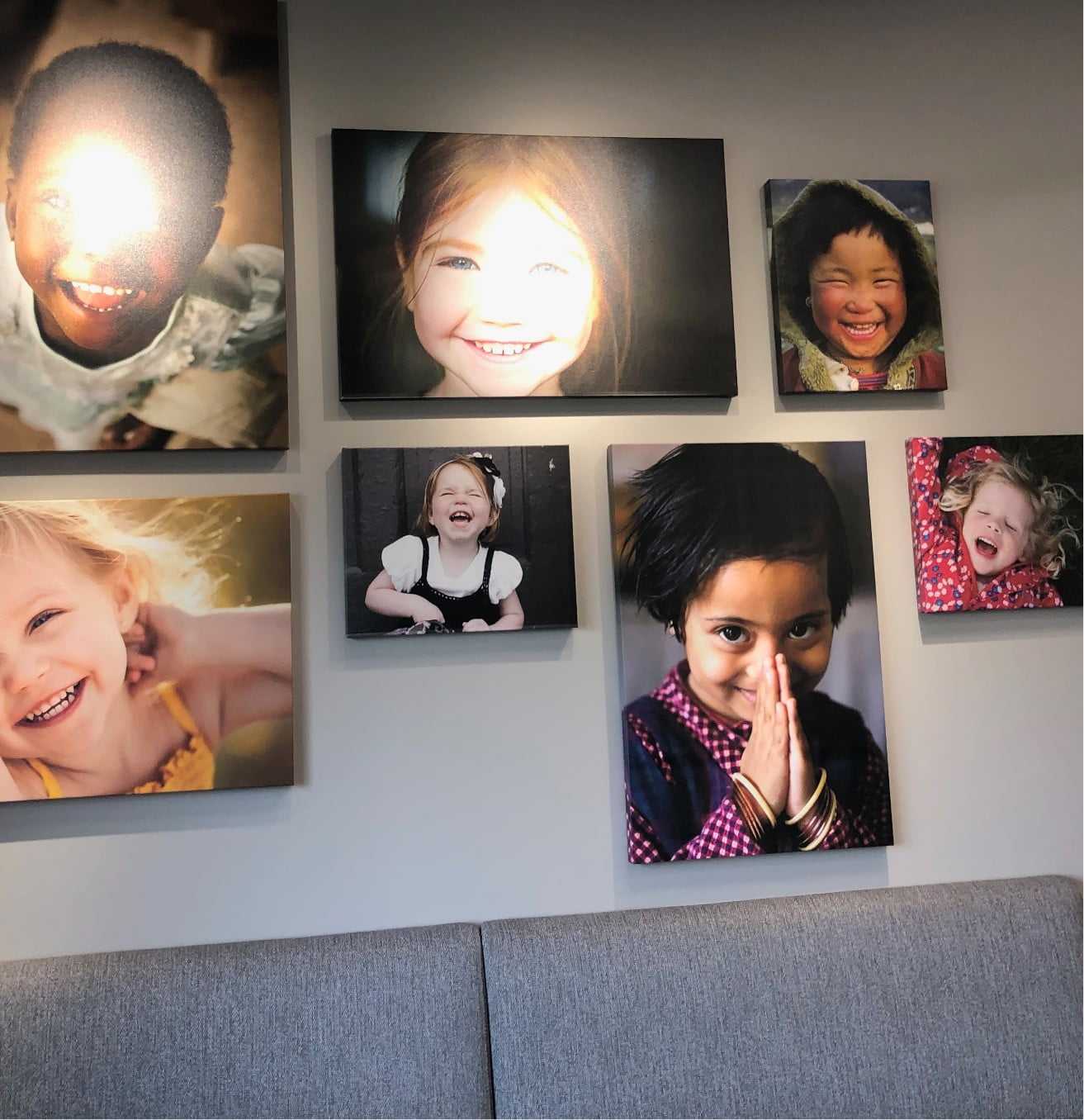 I picture of a wall of images of smiling kids